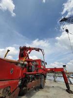 This is a process of casting concrete using a concrete pump to reach casting locations that are far away. photo