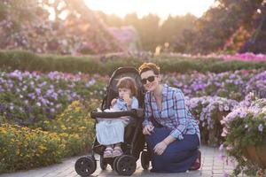 mother and daughter in flower garden photo