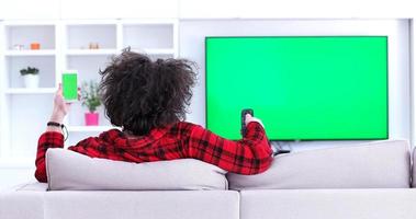 Young couple on the sofa watching television photo