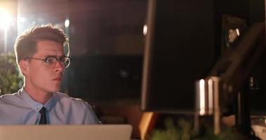 man working on computer in dark office photo