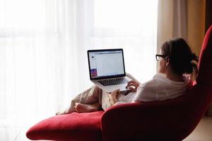 woman using a laptop computer at home photo