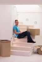 young man sitting in stairway at home photo