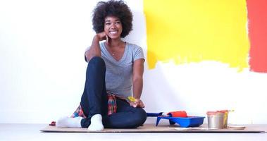 black female painter sitting on floor photo