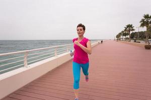 woman busy running on the promenade photo