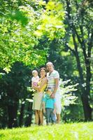 happy young couple with their children have fun at park photo