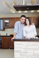 happy young couple have fun in modern kitchen photo