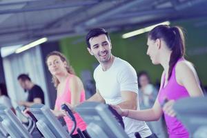 Group of people running on treadmills photo