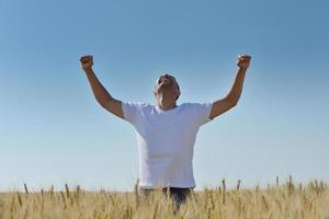 man in wheat field photo