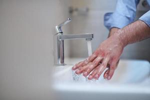 coronavirus male wahing hands in bathroom photo