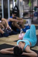 young athlete woman lying on the floor and relaxing photo