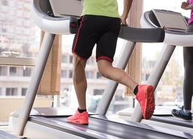 people exercisinng a cardio on treadmill in gym photo