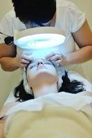 woman with facial mask in cosmetic studio photo