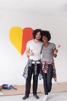 couple with painted heart on wall photo