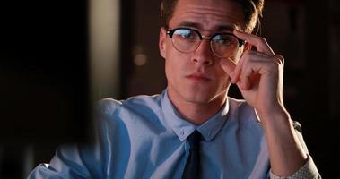 man working on computer in dark office photo