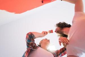 couple painting interior wall photo