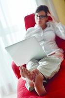 woman using a laptop computer at home photo