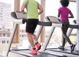 people exercisinng a cardio on treadmill in gym photo