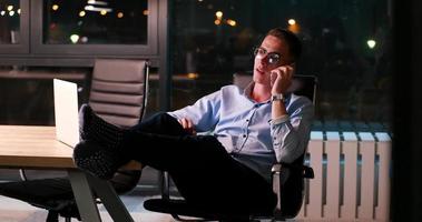 businessman sitting with legs on desk at office photo