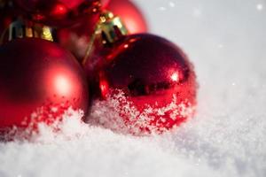 red christmas ball in fresh snow photo