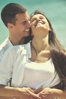 happy young couple have fun on beach photo