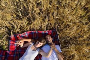 happy couple in wheat field photo