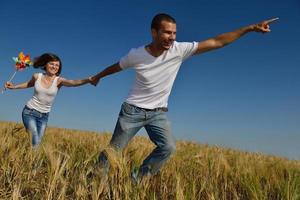 happy couple in wheat field photo
