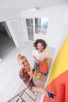 couple painting interior wall photo