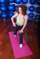 young pretty woman exercising in a fitness center photo