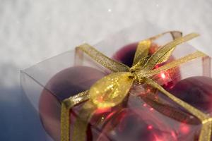 christmas ball in box on fresh  snow photo