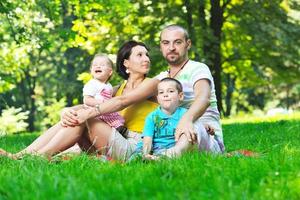 happy young couple with their children have fun at park photo