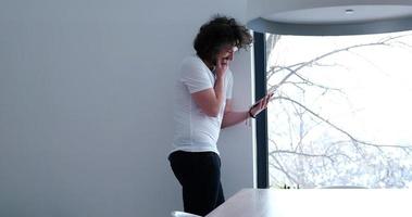 young man using a tablet at home photo