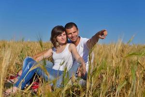 happy couple in wheat field photo