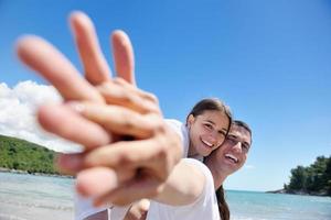 happy young couple have fun on beach photo