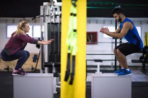 athletes working out  jumping on fit box photo