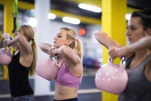 athletes doing exercises with kettlebells photo