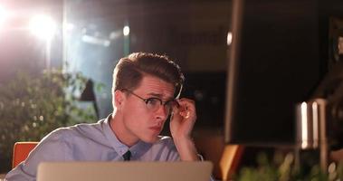 man working on computer in dark office photo