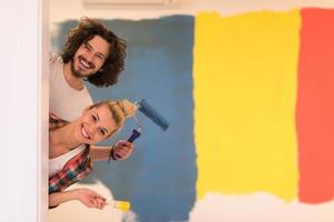 portrait of a couple painting interior wall photo