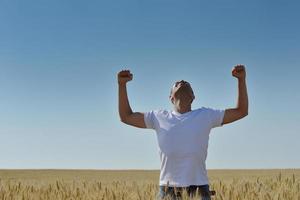 man in wheat field photo