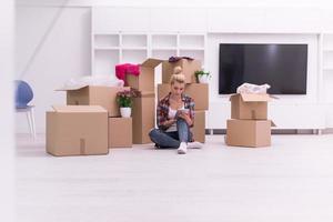 woman with many cardboard boxes sitting on floor photo