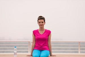 young woman sitting after a successful training run photo