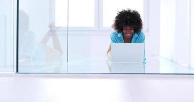 black women using laptop computer on the floor photo