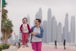 mother and cute little girl on the promenade photo