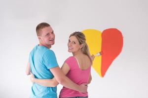 couple are painting a heart on the wall photo