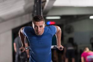 man doing exercises parallel bars photo