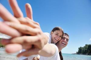 happy couple have fun on the beach photo