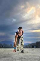 young man jumping in air outdoor at night ready to party photo