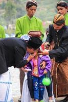 Dieng, Indonesia - August 1, 2015. Dieng Culture Festival, Tourists follow the dreadlocks procession during the Dieng Culture Festival event at Dieng, Banjarnegara district, Central Java photo