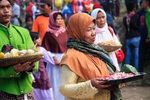 Dieng, Indonesia - August 1, 2015. Dieng Culture Festival, Tourists follow the dreadlocks procession during the Dieng Culture Festival event at Dieng, Banjarnegara district, Central Java photo