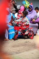 Dieng, Indonesia - August 1, 2015. Dieng Culture Festival, Tourists follow the dreadlocks procession during the Dieng Culture Festival event at Dieng, Banjarnegara district, Central Java photo