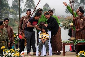 Dieng, Indonesia - August 1, 2015. Dieng Culture Festival, Tourists follow the dreadlocks procession during the Dieng Culture Festival event at Dieng, Banjarnegara district, Central Java photo